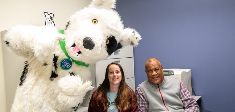 Chaser and two SCC employees at a desk