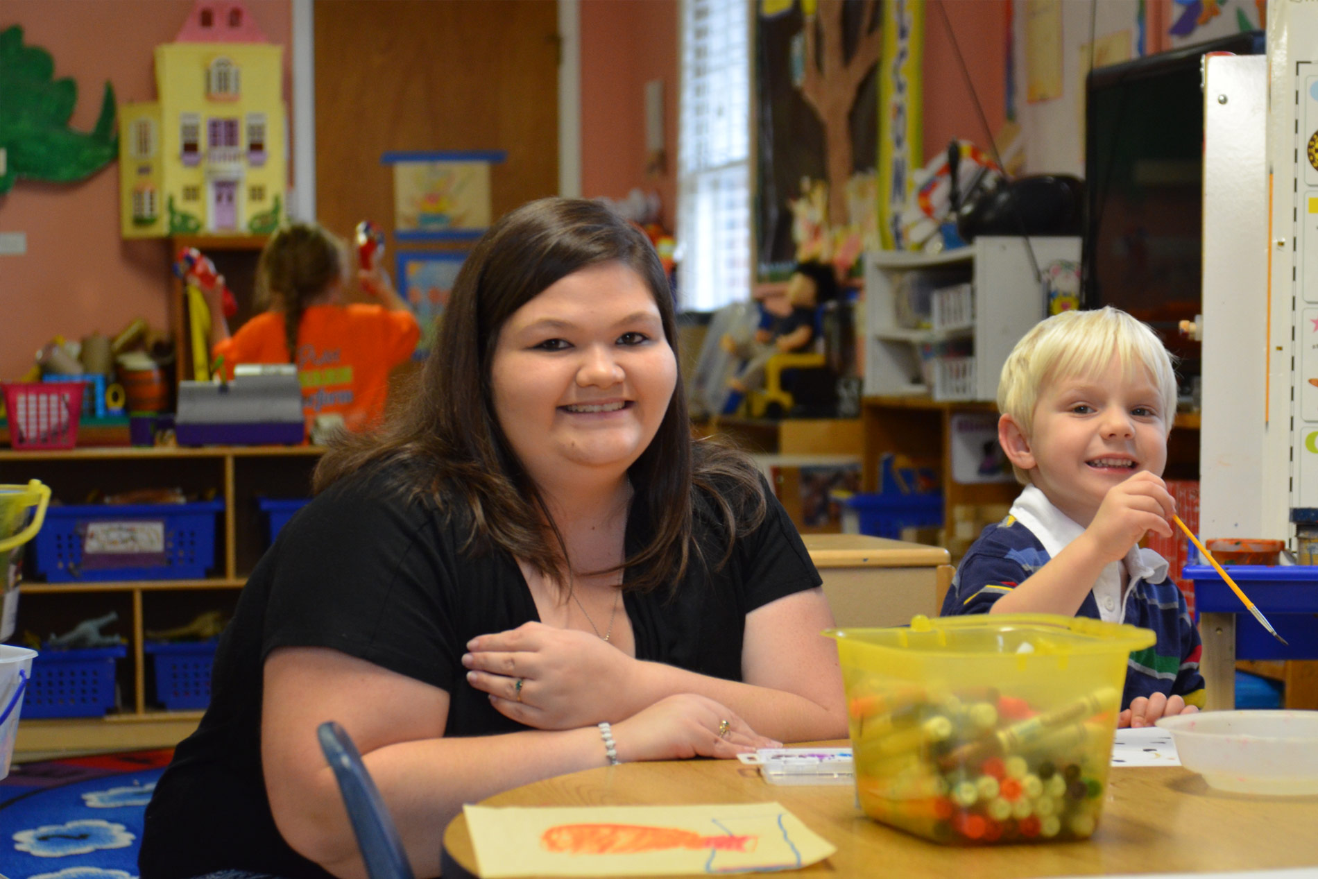 Young student and teacher in classroom