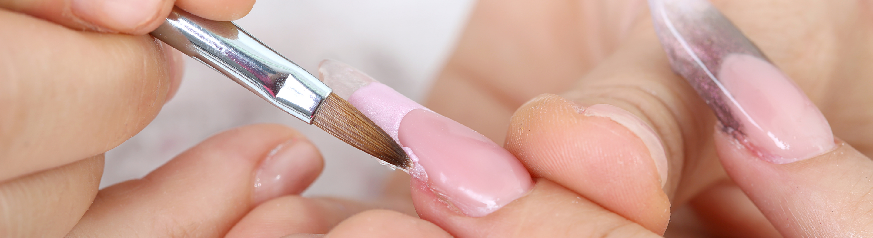 Close up image of one set of hands taking care of someones nails