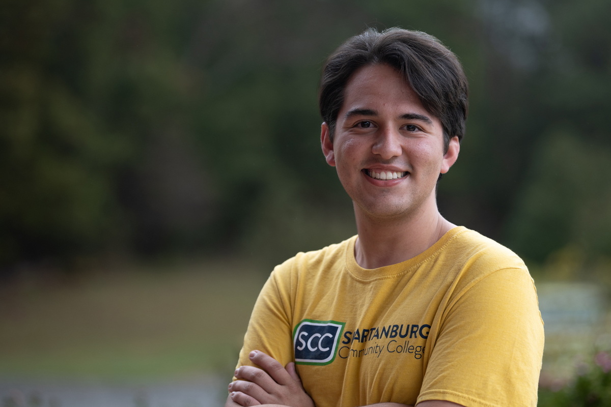 Smiling student in SCC logo shirt