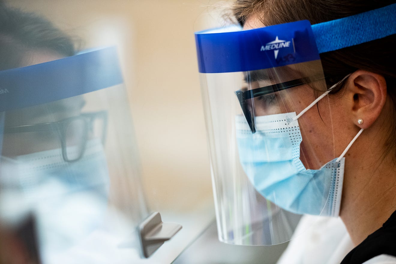 Medical technologist Emily Neverett prepares COVID-19 swabs for analysis at the Luxor Scientific Lab in Greenville