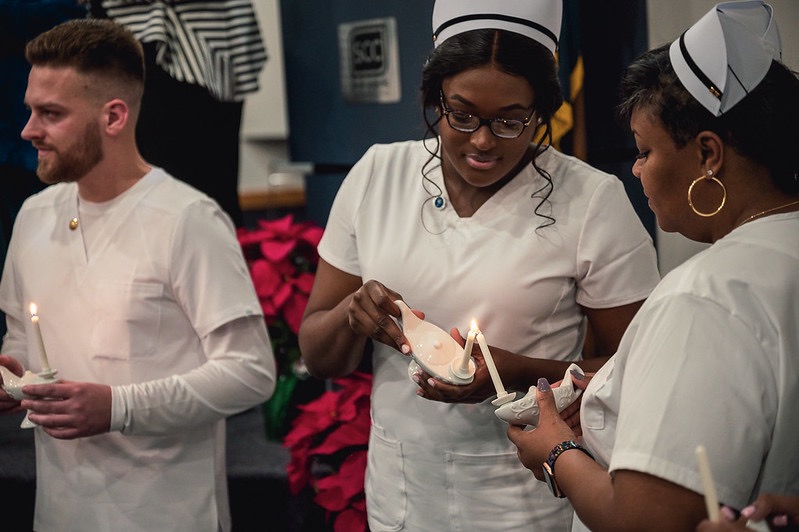 SCC Nursing Students Light Ceremonial Lamps During a Pinning Ceremony