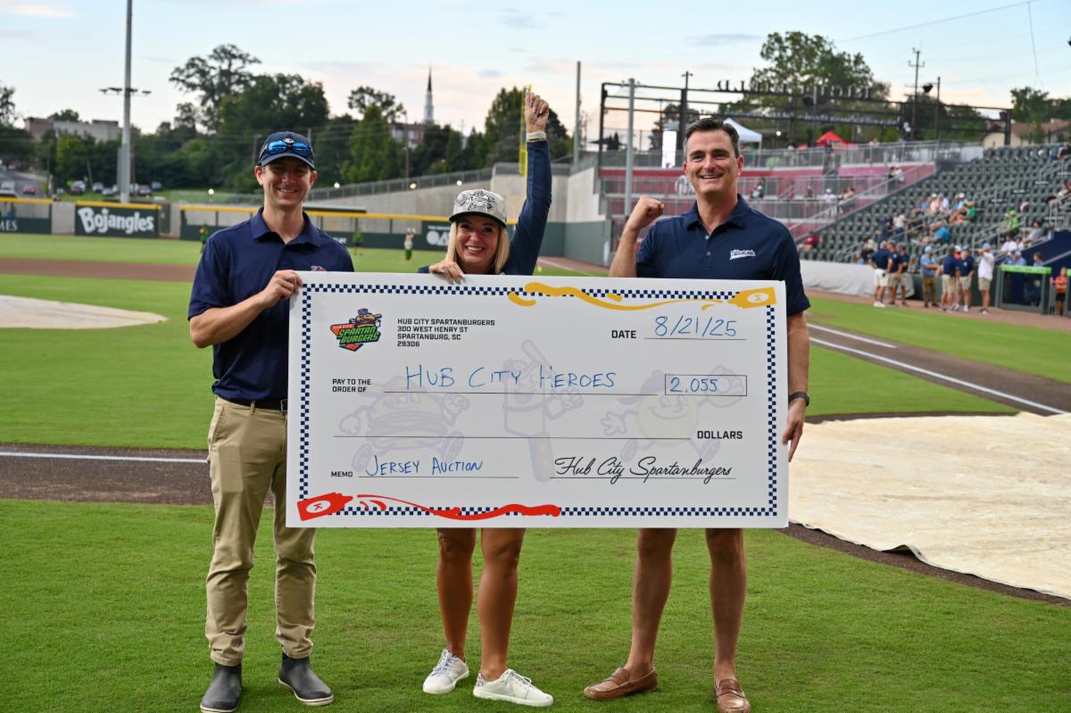 Image of SCC's President Mikota and Dr. Obi receiving donation from Spartanburgers